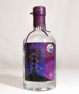 A 70cl gin bottle, with a dark purple wax style seal, and a purple label with a stylised tree on it - design by Iain Clark